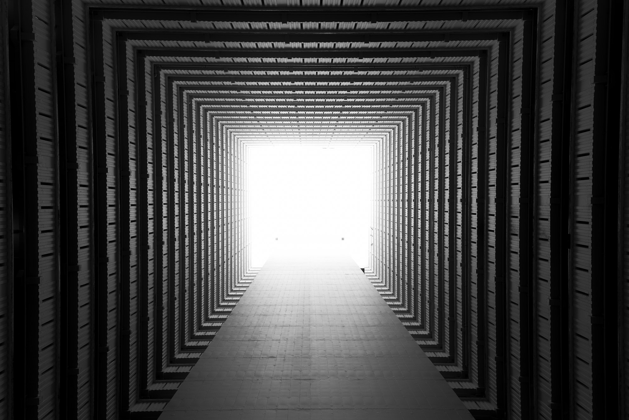 A view of Hong Kong buildings from the group looking up appears as if staring down a long corridor