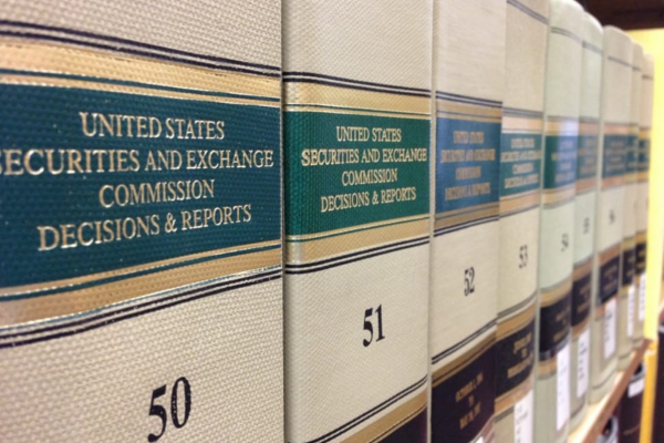A bookshelf full of securities and exchanges commissions decisions and reports