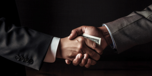 Shaddy handshake with exchange of money