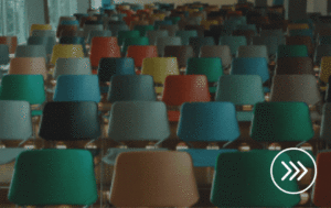 Photo of classroom chairs with a moving arrow in the bottom right corner