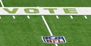 VOTE is painted on the sideline of an NFL football field