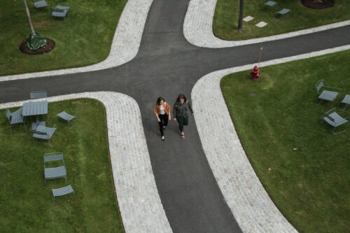 birdseye view of the HKS courtyard with two students walking in the middle