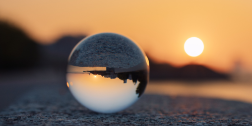 A lens reflecting the sunset over a body of water.