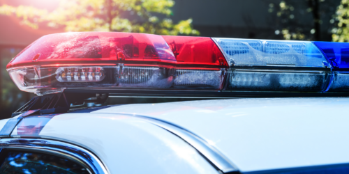 A photo of police car lights on top of a police car.