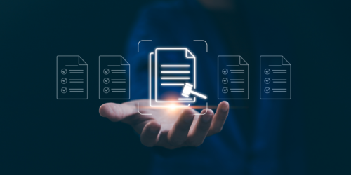 An outstretched hand holding up graphics of paper and a gavel.