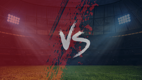 A red and blue graphic with versus in the middle at a sports stadium.
