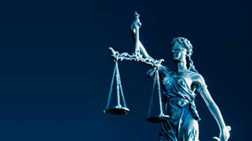 A statue of Lady Liberty holding scales of justice.