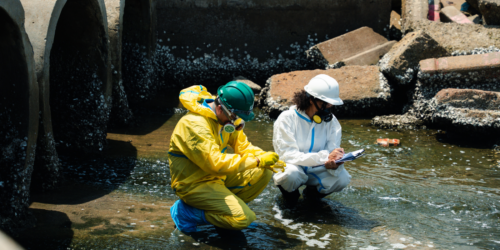 Workers testing chemicals