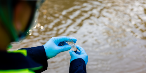 Worker testing contaminants in the water